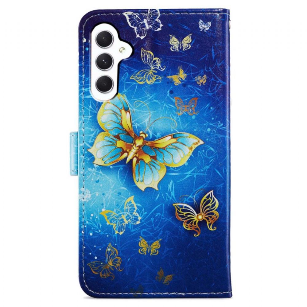 Kožený Kryt Na Samsung Galaxy A55 5g Zlatý Motýl Na Modrém Pozadí S Páskem