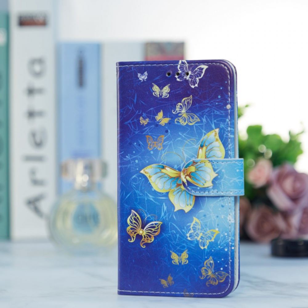 Kožený Kryt Na Samsung Galaxy A55 5g Zlatý Motýl Na Modrém Pozadí S Páskem
